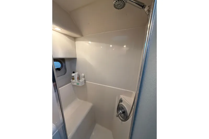 Slide: The Image of Shower area in 2001 Bayliner 3388 Command Bridge Motoryacht, featuring modern fixtures and storage. - 76