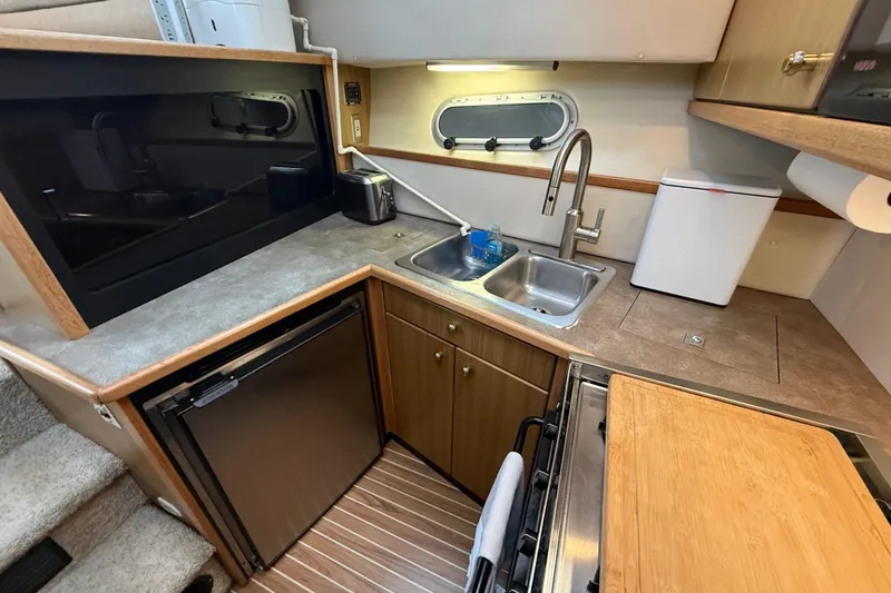 Slide: The Image of Kitchen area of 2001 Bayliner 3388 Command Bridge Motoryacht with sink and appliances. - 78