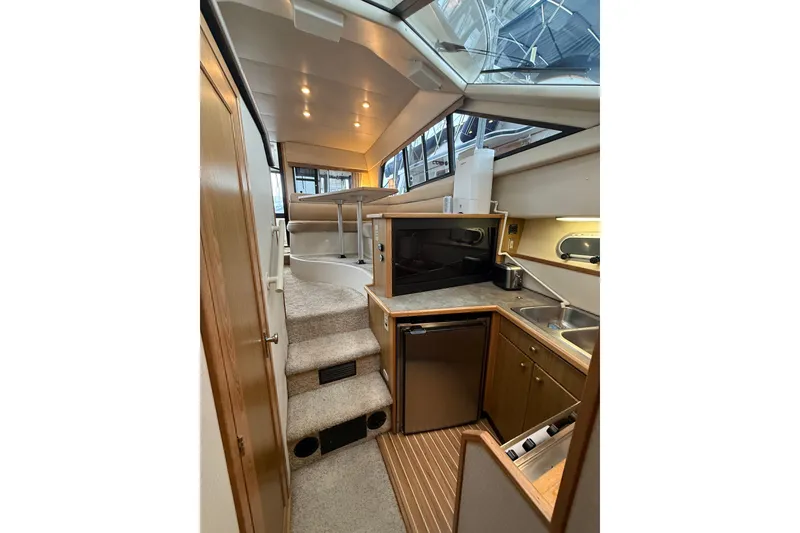 Slide: The Image of Interior of 2001 Bayliner 3388 Command Bridge Motoryacht with kitchenette and stairs. - 79