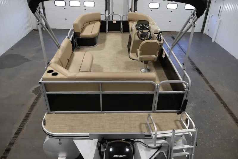 Slide: The Image of 2022 Harris Cruiser LX180 Cruise pontoon boat interior with beige seating and steering console. - 10