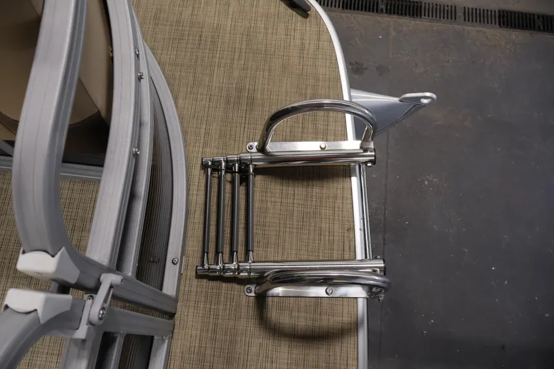 Slide: The Image of 2022 Harris Cruiser LX180 Cruise boat ladder on deck, featuring metal and wood textures. - 11