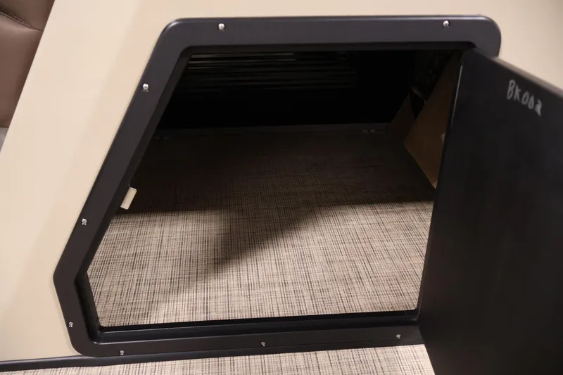 Slide: The Image of Open storage compartment on 2022 Harris Cruiser LX180 Cruise boat. - 16