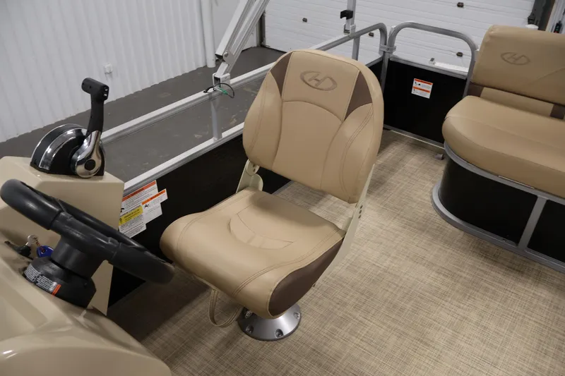 Slide: The Image of 2022 Harris Cruiser LX180 Cruise boat interior with beige captain's chair and steering console. - 21