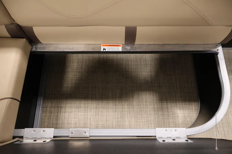 Slide: The Image of Interior view of 2022 Harris Cruiser LX180 Cruise boat seating area with storage compartment. - 23