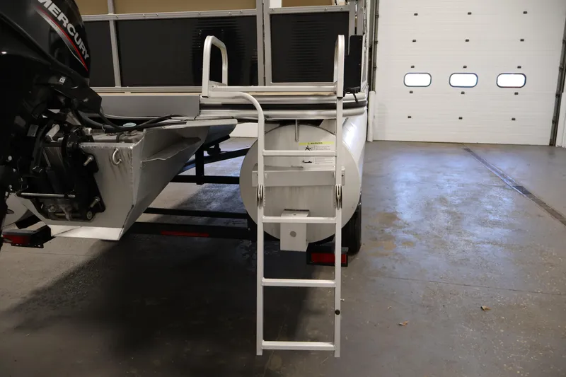 Slide: The Image of 2022 Harris Cruiser LX180 Cruise boat with ladder and Mercury engine in garage. - 25