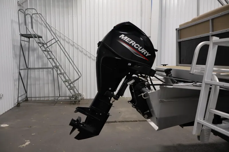 Slide: The Image of 2022 Harris Cruiser LX180 Cruise with Mercury outboard motor in a storage facility. - 27