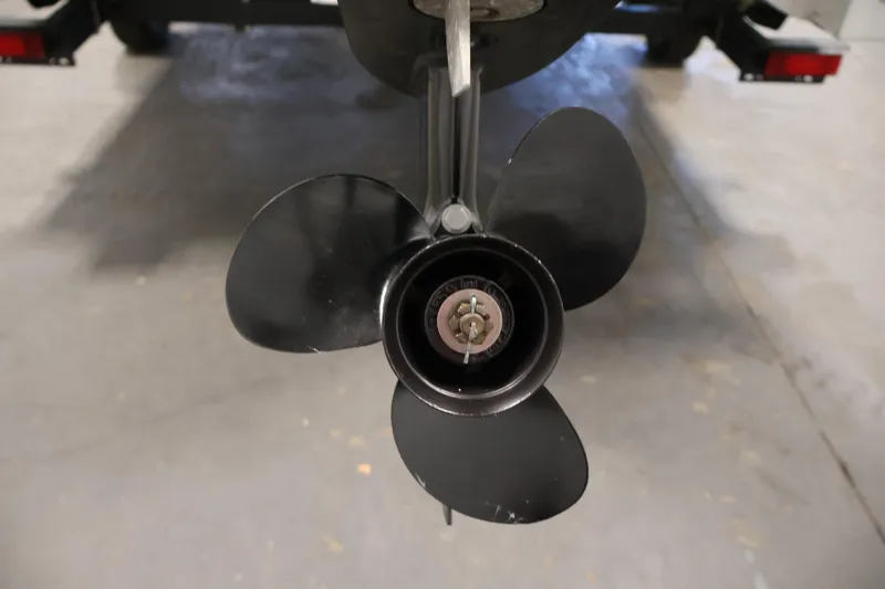 Slide: The Image of Propeller of 2022 Harris Cruiser LX180 Cruise boat in a garage setting. - 29