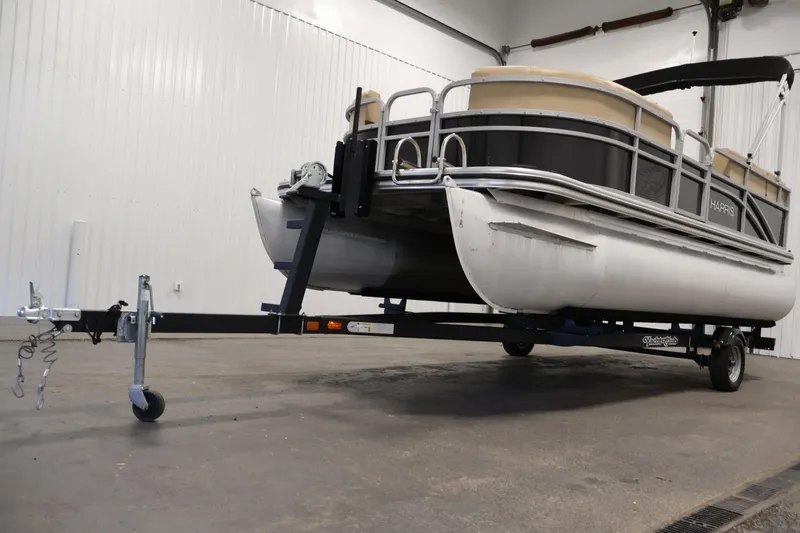 Slide: The Image of 2022 Harris Cruiser LX180 pontoon boat on trailer in indoor storage. - 32
