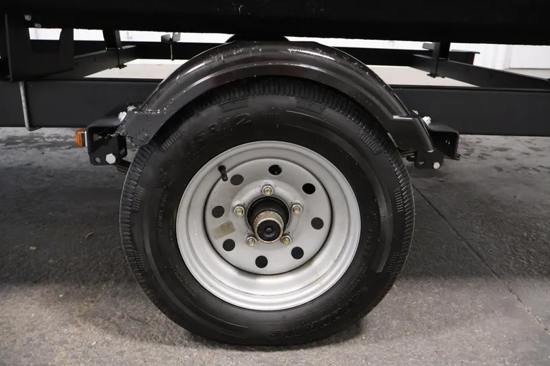 Slide: The Image of Trailer wheel of a 2022 Harris Cruiser LX180 Cruise boat. - 33