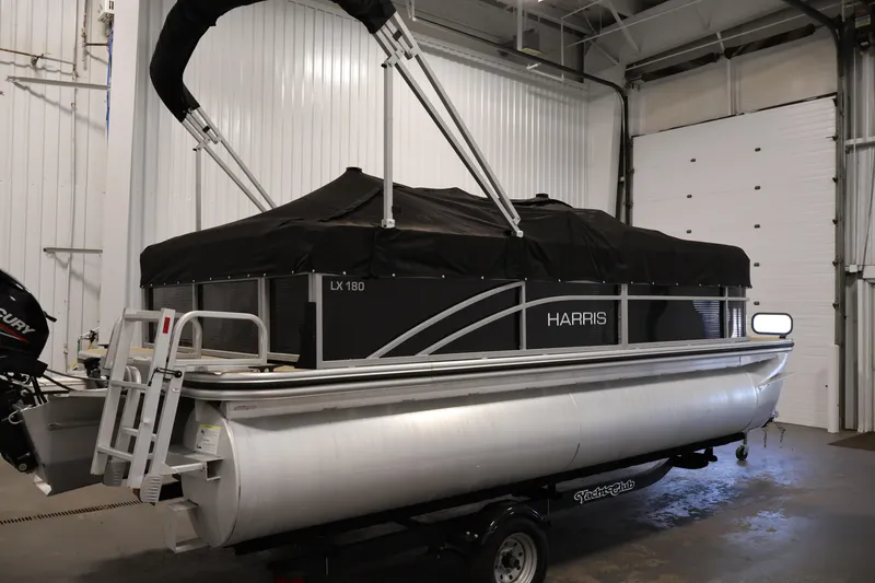 Slide: The Image of 2022 Harris Cruiser LX180 pontoon boat in indoor storage. - 34