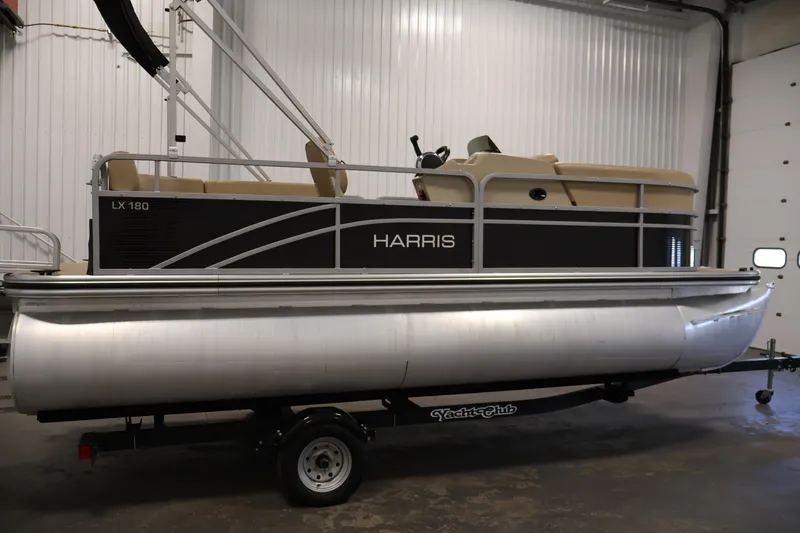 Slide: The Image of 2022 Harris Cruiser LX180 pontoon boat on trailer in indoor setting. - 4