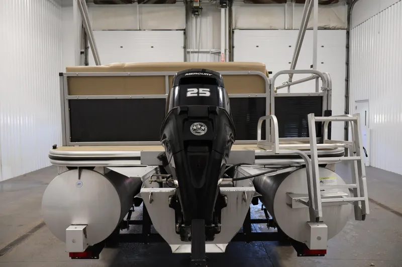 Slide: The Image of 2022 Harris Cruiser LX180 pontoon boat with Mercury 25 engine in a garage. - 6