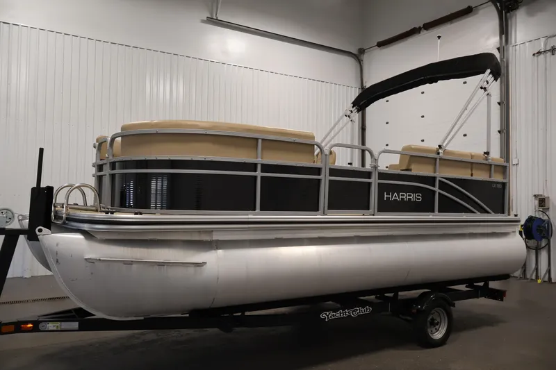 Slide: The Image of 2022 Harris Cruiser LX180 pontoon boat on trailer in indoor storage. - 8