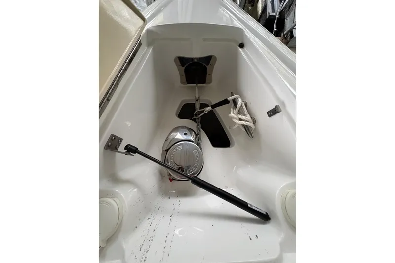 Slide: The Image of Interior view of a 2017 Cobalt R35 boat's anchor compartment with rope and winch. - 25