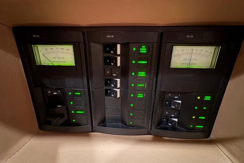 Slide: The Image of Electrical control panel in a 2017 Cobalt R35 boat, featuring AC and DC voltage meters. - 28