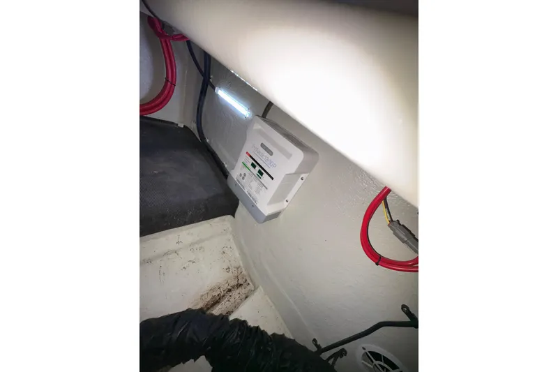 Slide: The Image of Electrical setup inside a 2017 Cobalt R35 boat, featuring wiring and a control box. - 34