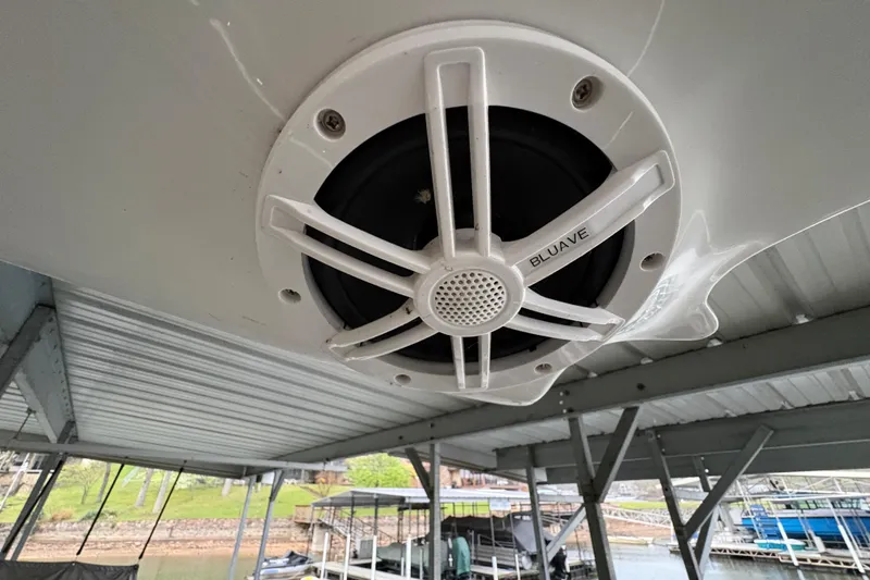 Slide: The Image of Boat speaker on a 2017 Cobalt R35, docked near a marina. - 37