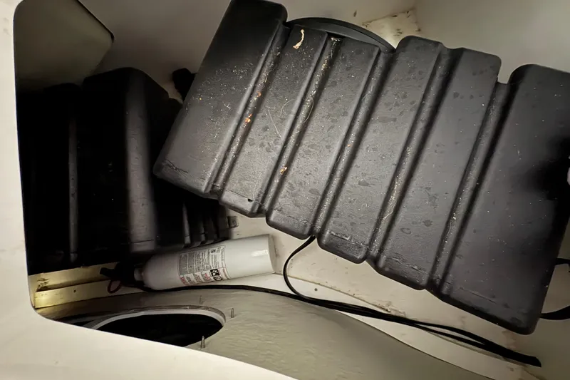 Slide: The Image of 2017 Cobalt R35 boat battery compartment with fire extinguisher. - 39