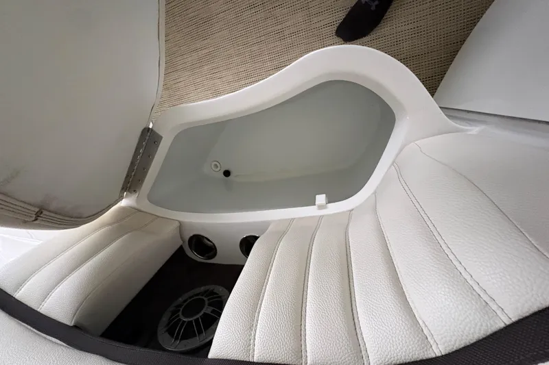 Slide: The Image of Interior view of a 2017 Cobalt R35 boat, featuring white leather seating and storage compartment. - 42