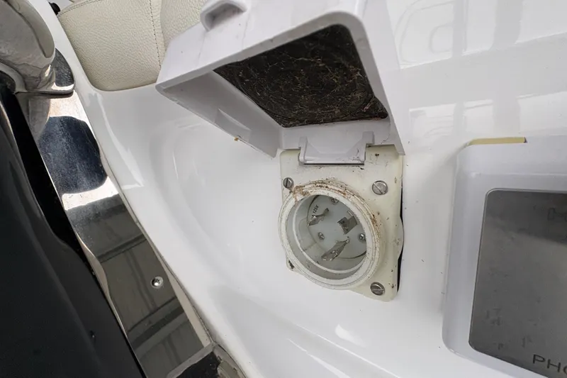 Slide: The Image of Boat power outlet on a 2017 Cobalt R35, featuring a protective cover. - 49