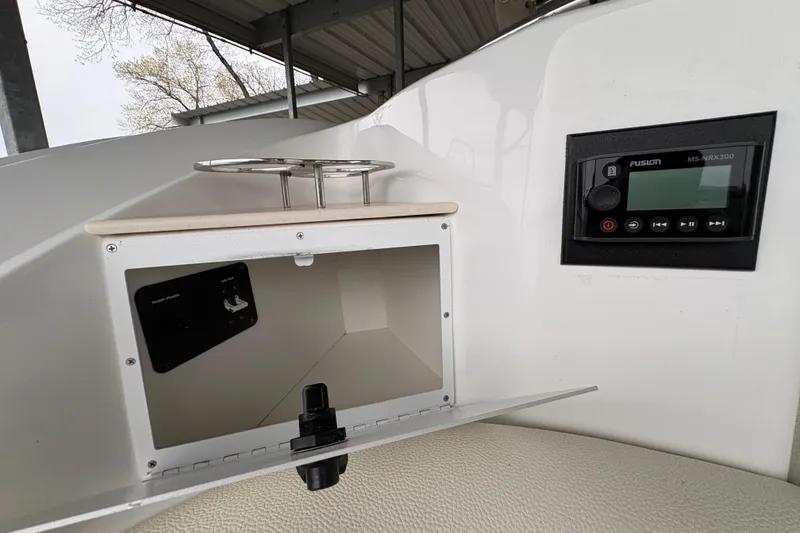 Slide: The Image of 2017 Cobalt R35 boat dashboard with open compartment and Fusion MS-NRX300 stereo. - 50