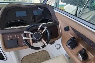Slide: The Image of Interior view of a 2017 Cobalt R35 boat cockpit with steering wheel and navigation display. - 6