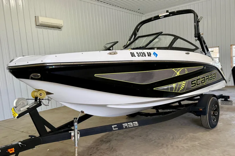 The Image of 2023 Scarab 195 ID boat on trailer in indoor storage facility. - 0