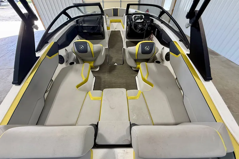 Slide: The Image of 2023 Scarab 195 ID boat interior with gray and yellow seating, steering wheel, and dashboard. - 16