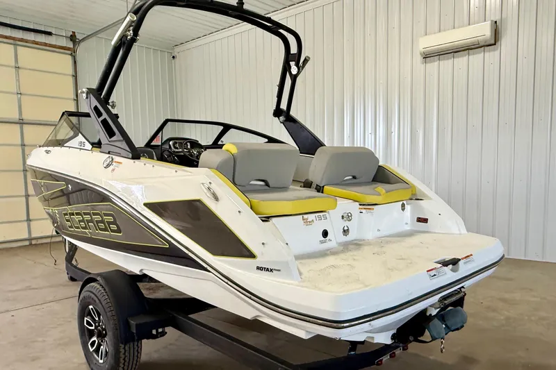 Slide: The Image of 2023 Scarab 195 ID boat on trailer in a garage setting. - 5