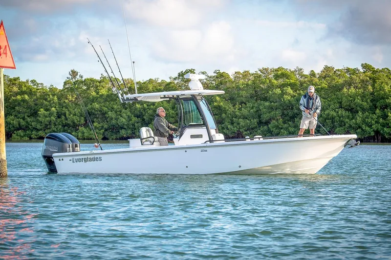 The Image of Manufacturer Provided Image: 2026 Everglades 273 Center Console boat on water, two people fishing, lush greenery background. - 0