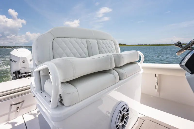 Slide: The Image of 2026 Everglades 273 Center Console boat with luxurious seating and Mercury engine on open water. - 16
