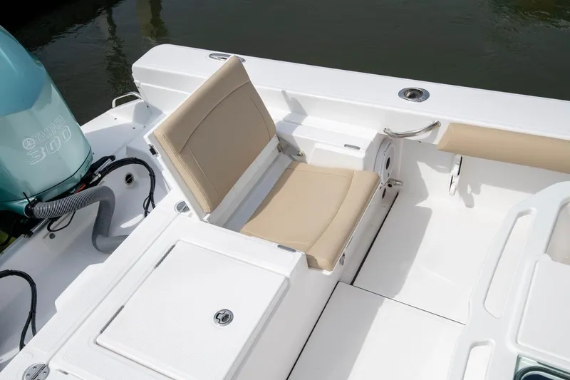 Slide: The Image of 2026 Everglades 273 Center Console boat interior with beige seating and Yamaha 300 engine. - 11