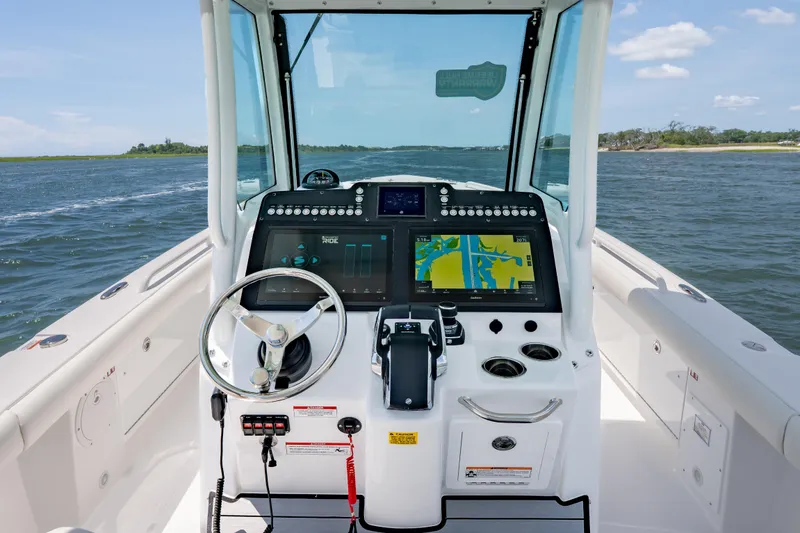Slide: The Image of 2026 Everglades 273 Center Console boat dashboard with navigation screens on open water. - 13