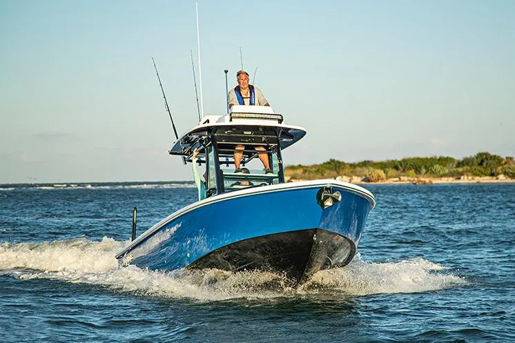Slide: The Image of Manufacturer Provided Image: 2025 Everglades 273 Center Console boat cruising on open water. - 2