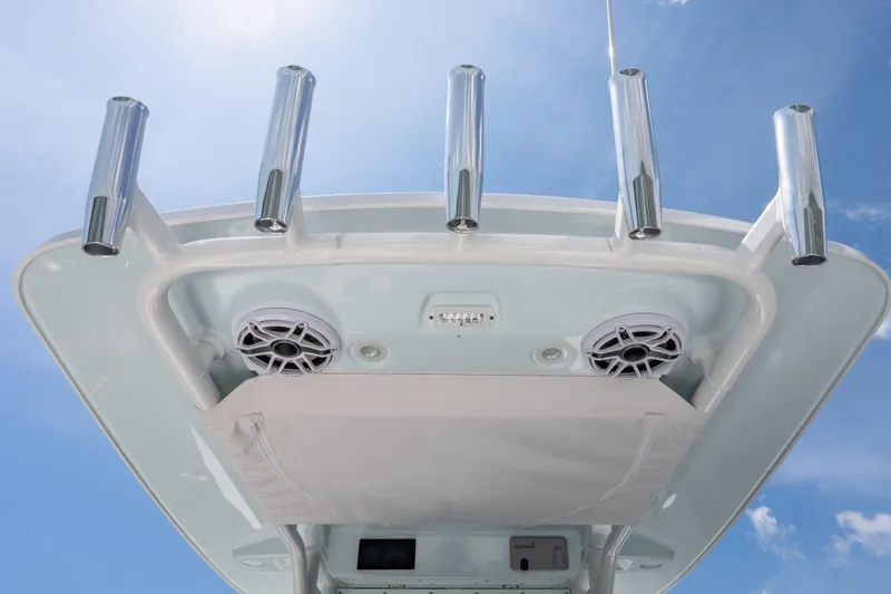 Slide: The Image of 2026 Everglades 273 Center Console boat with rod holders and speakers under a clear sky. - 11