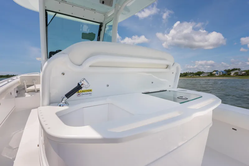 Slide: The Image of 2026 Everglades 273 Center Console boat with sleek white interior and ocean backdrop. - 17