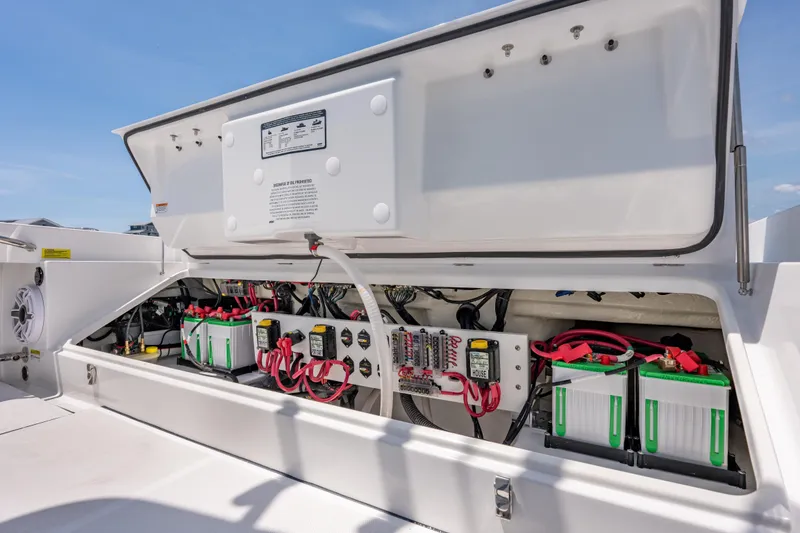 Slide: The Image of Open electrical compartment of 2026 Everglades 273 Center Console boat, showcasing wiring and batteries. - 21