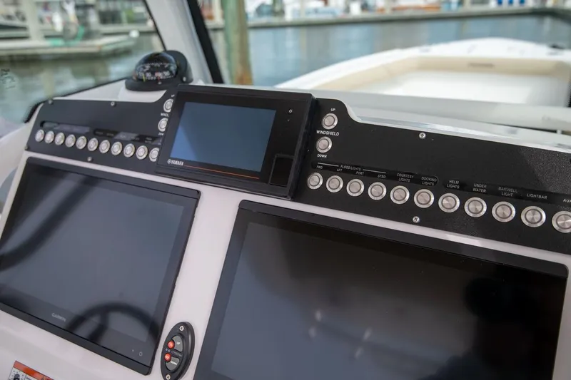 Slide: The Image of Dashboard of 2026 Everglades 273 Center Console boat with navigation screens and controls. - 8
