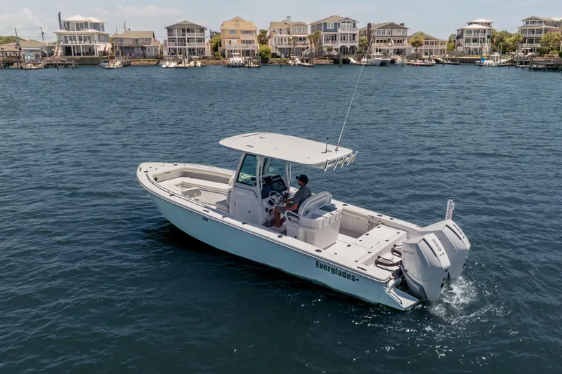 Slide: The Image of 2026 Everglades 273 Center Console boat cruising on a scenic waterfront. - 4