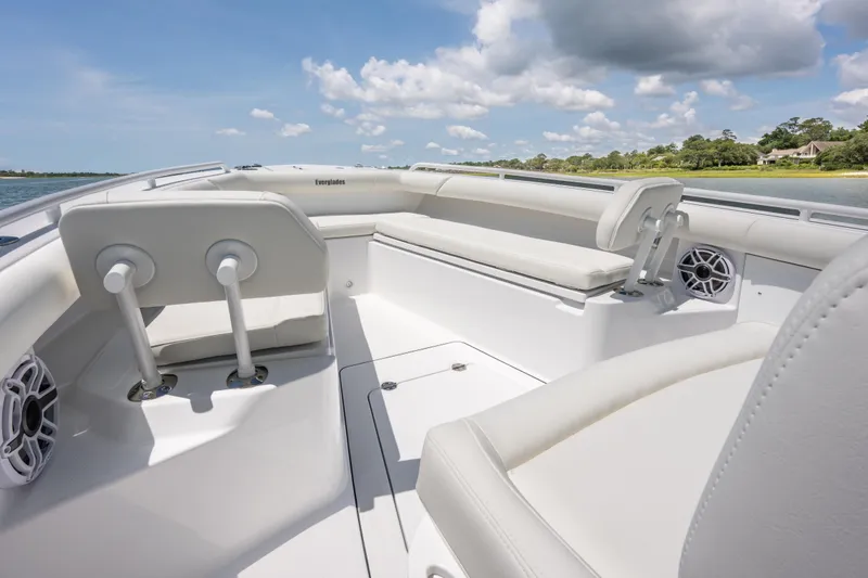 Slide: The Image of 2026 Everglades 273 Center Console boat interior with white seating and speakers. - 9