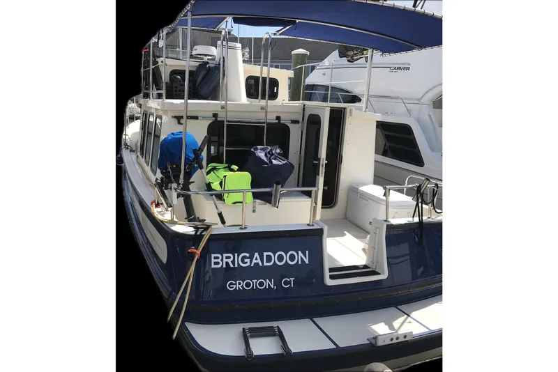 The Image of Nordic Tug 32, 2002 model, docked in Groton, CT, with visible deck and equipment. - 0