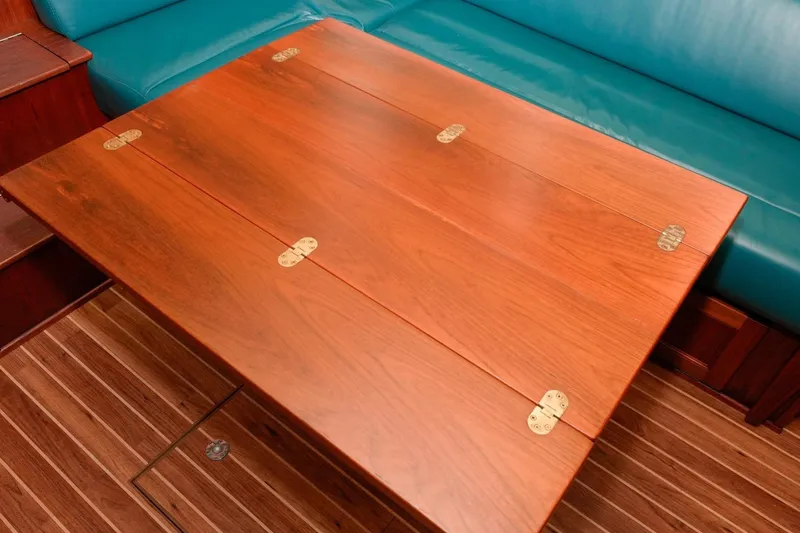 Slide: The Image of Wooden table with brass hinges on 2002 Nordic Tug 32. - 7