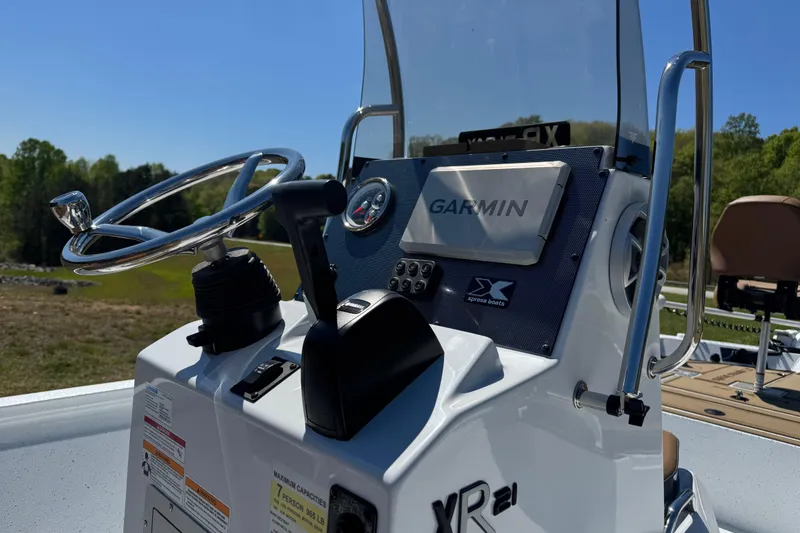 Slide: The Image of 2026 Xpress XR21 Bay boat console with Garmin navigation system and steering wheel. - 12