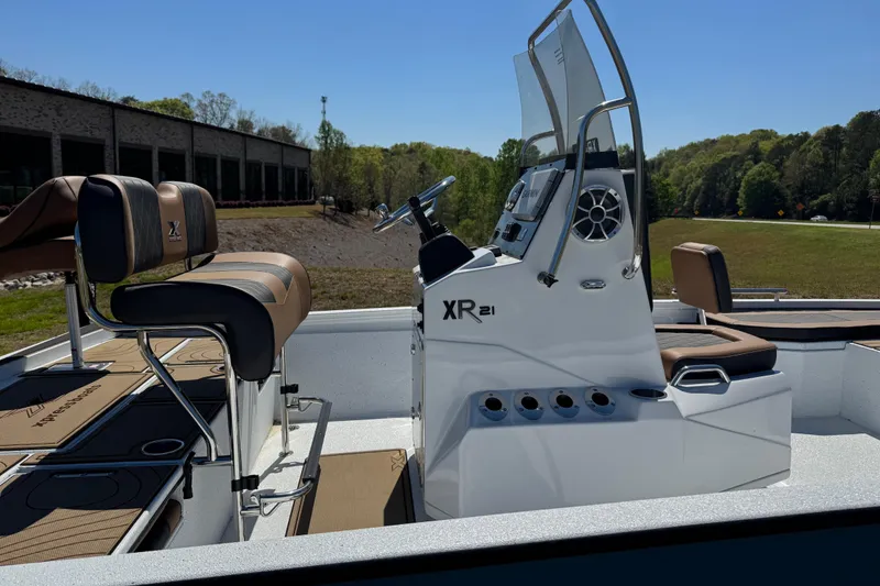 Slide: The Image of 2026 Xpress XR21 Bay boat with sleek console and seating, outdoors on a sunny day. - 13