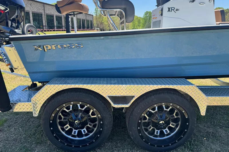 Slide: The Image of 2026 Xpress XR21 Bay boat on a trailer with stylish wheels. - 14