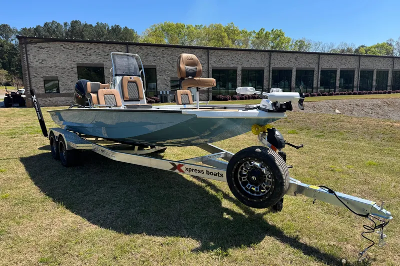 Slide: The Image of 2026 Xpress XR21 Bay boat on trailer in front of building. - 15