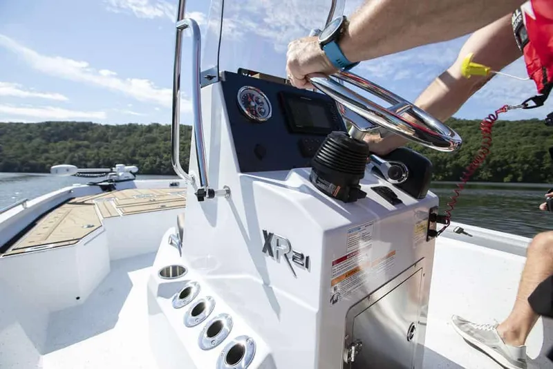 Slide: The Image of Manufacturer Provided Image: 2026 Xpress XR21B Bay boat steering console on a sunny lake. - 18