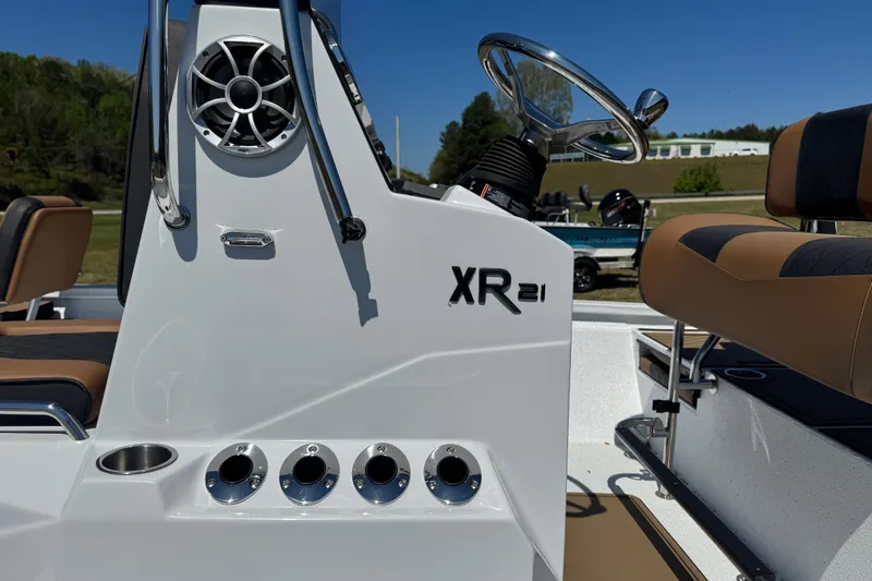 Slide: The Image of 2026 Xpress XR21 Bay boat console with steering wheel and seating. - 2