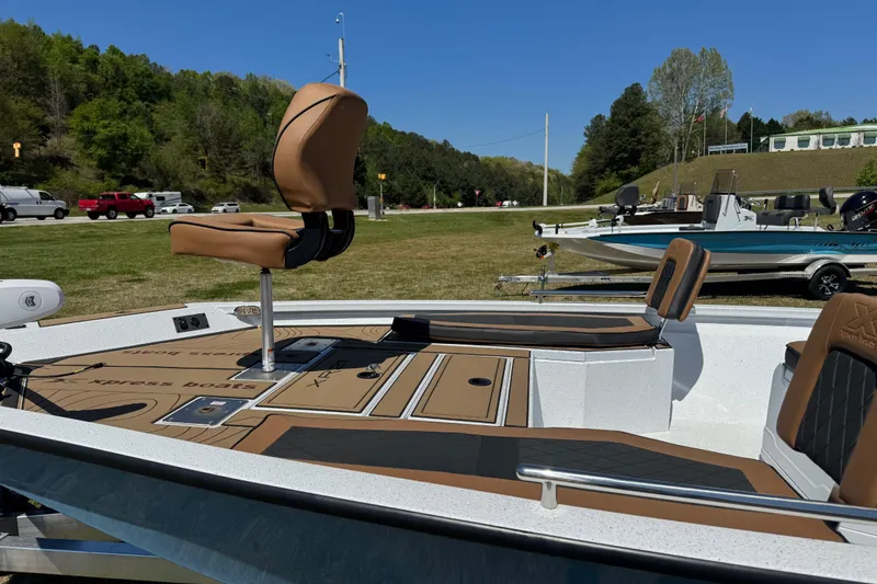 Slide: The Image of 2026 Xpress XR21 Bay boat with tan seating, parked outdoors. - 5