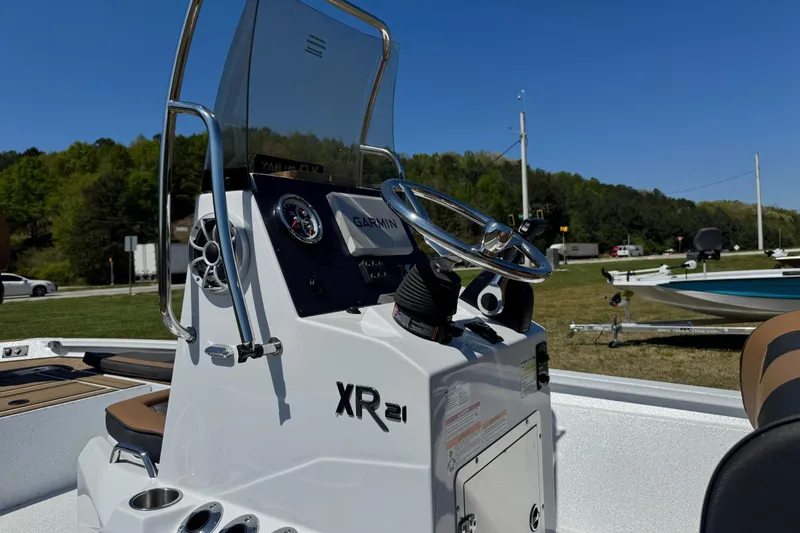 Slide: The Image of 2026 Xpress XR21 Bay boat console with steering wheel and Garmin display. - 7
